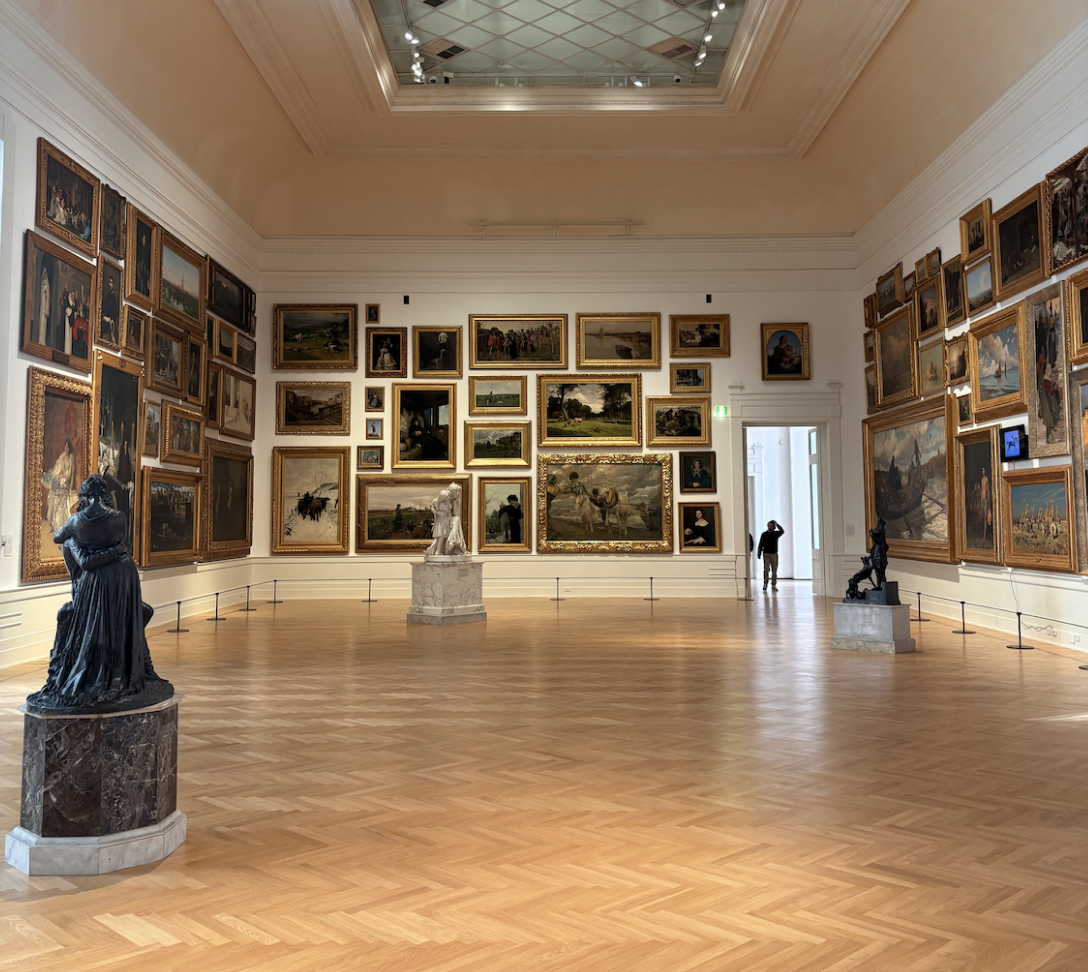 Paintings and sculptures in a museum gallery.