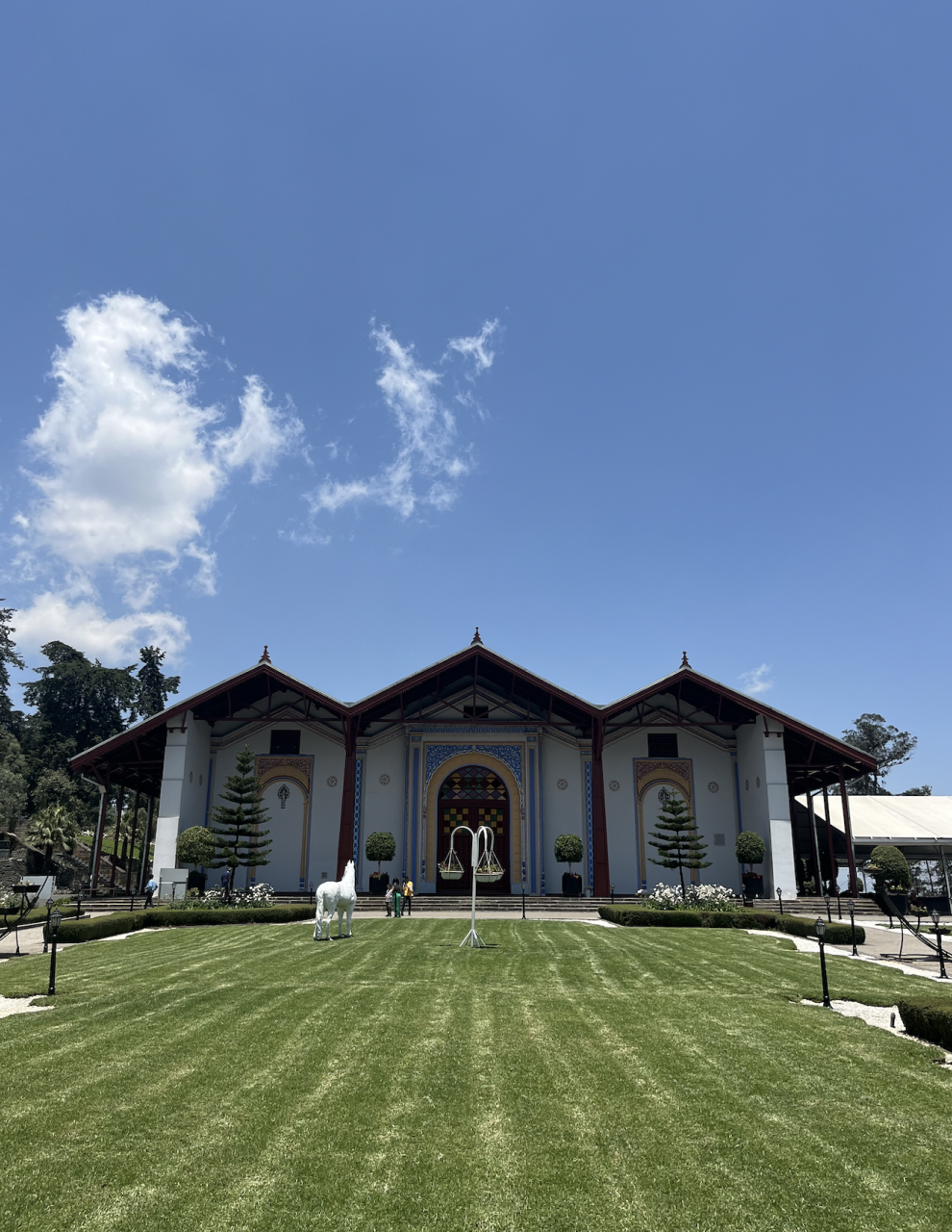 A building and green lawn beneath a blue sky in Ethiopia.