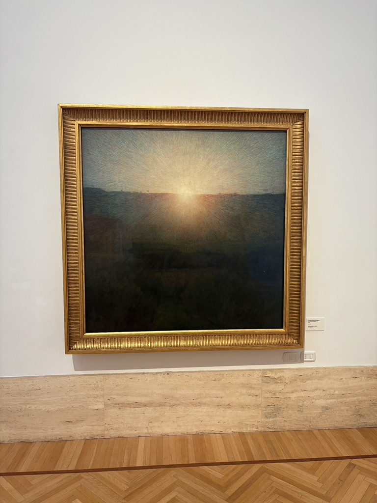 A framed painting of sunlight on a museum wall.