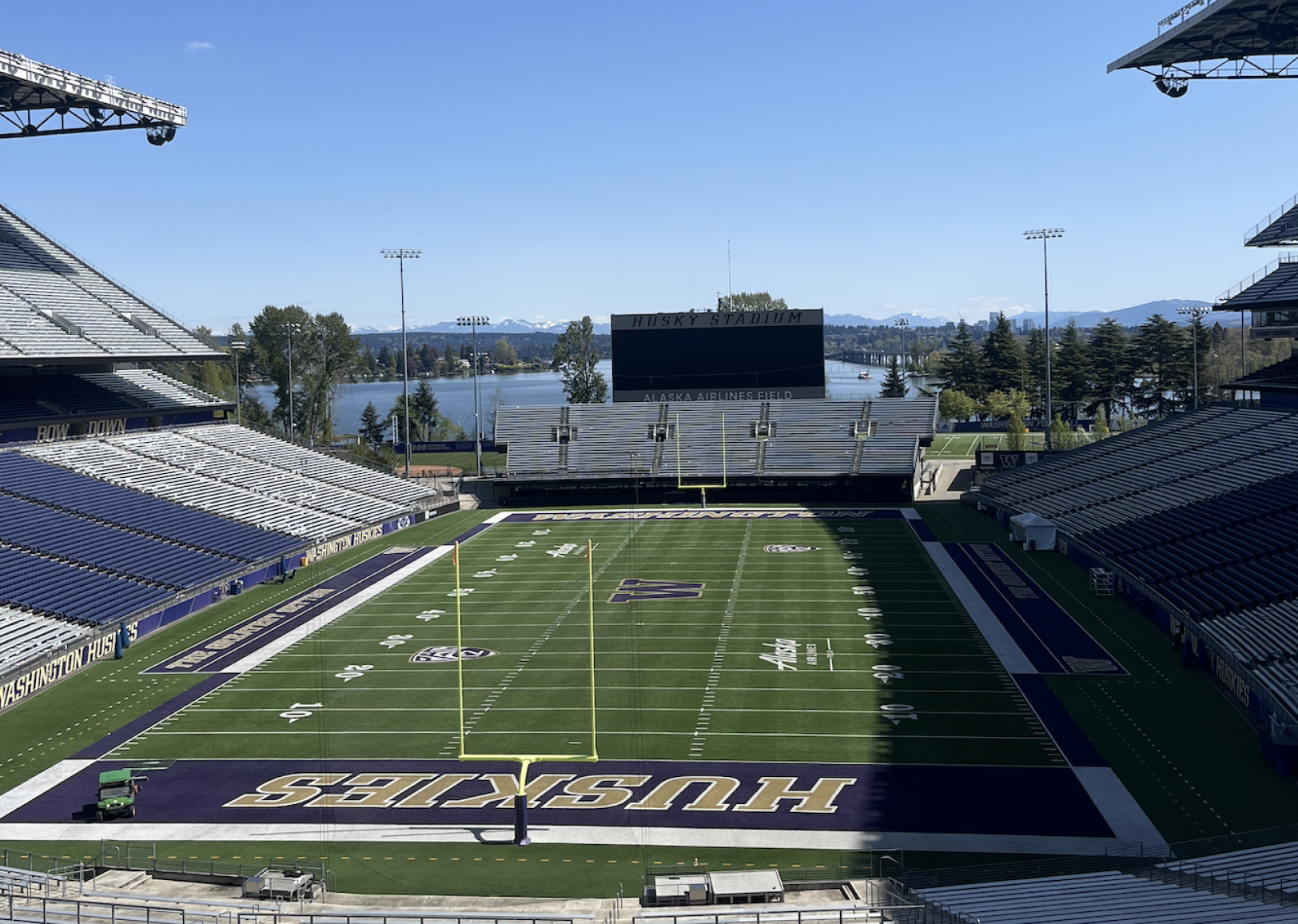 Husky Stadium overlooking the water on a sunny day.